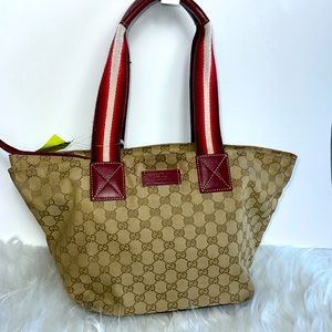 Gucci logo handbag purse with leather bottom and at top of handles